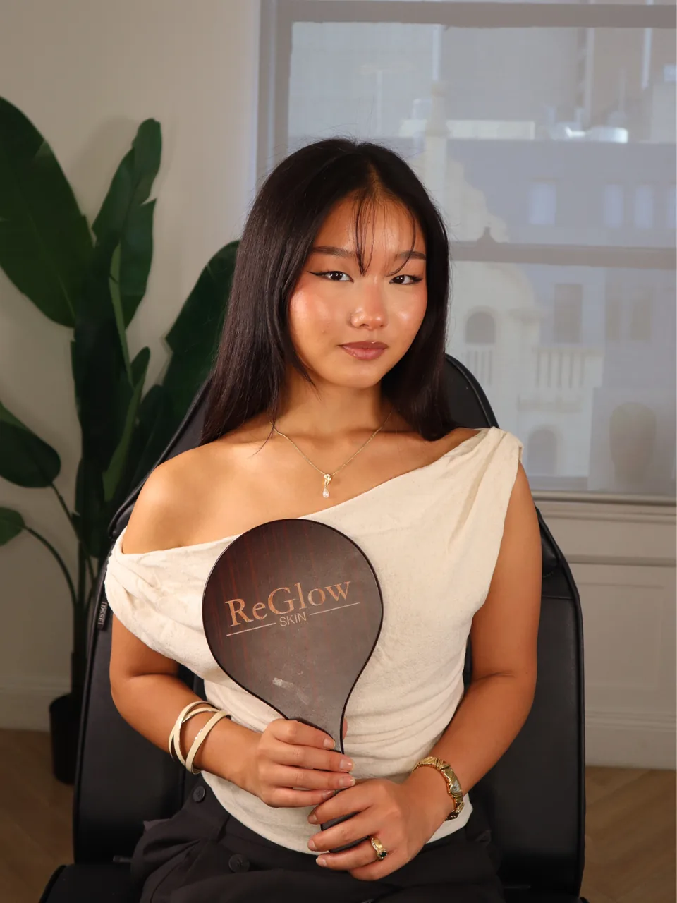 A ReGlow Skin client seated in the treatment chair at an InMode MiniFX consultation in Melbourne